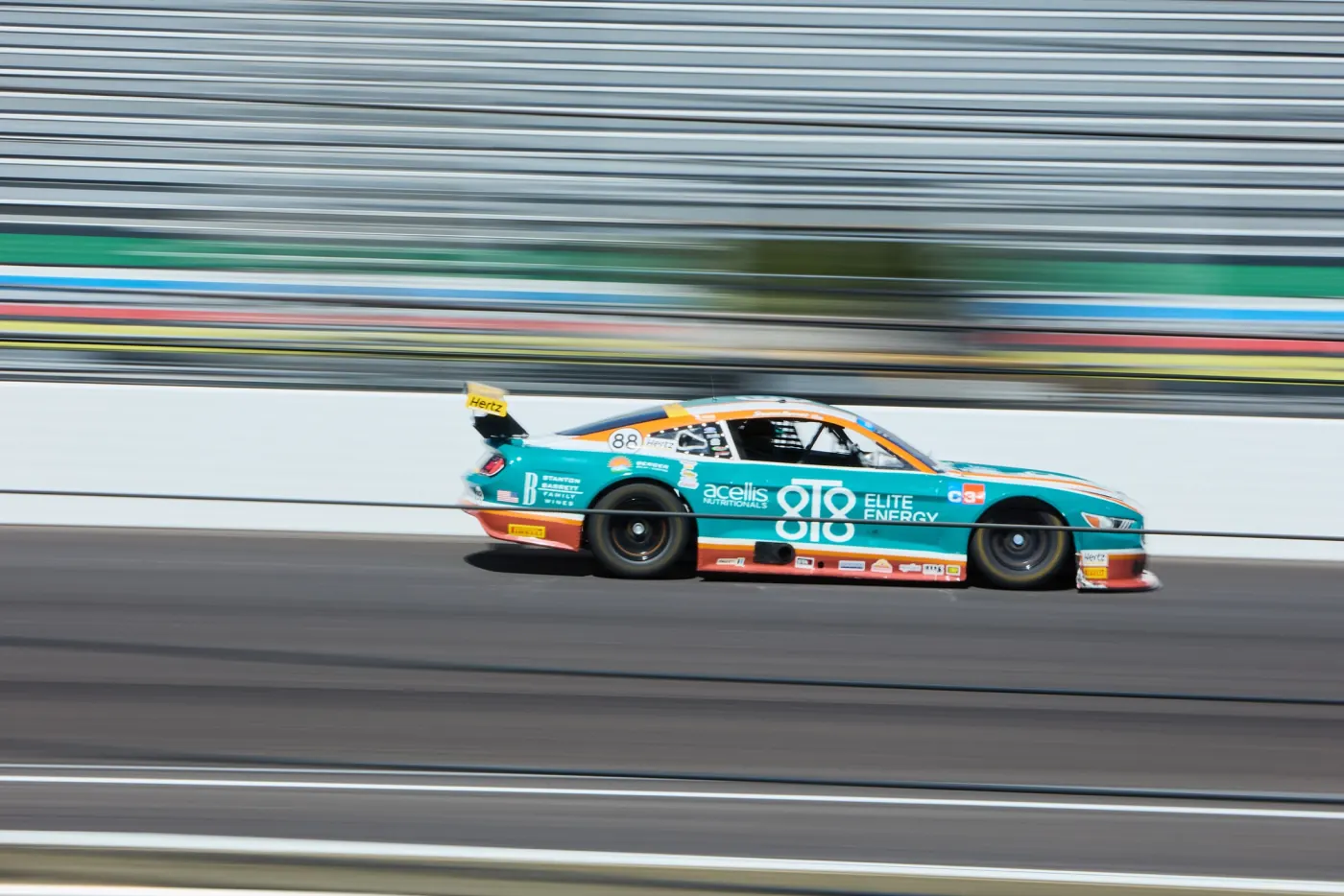 The Acellis 8T8 Ford Mustang at speed on a road course