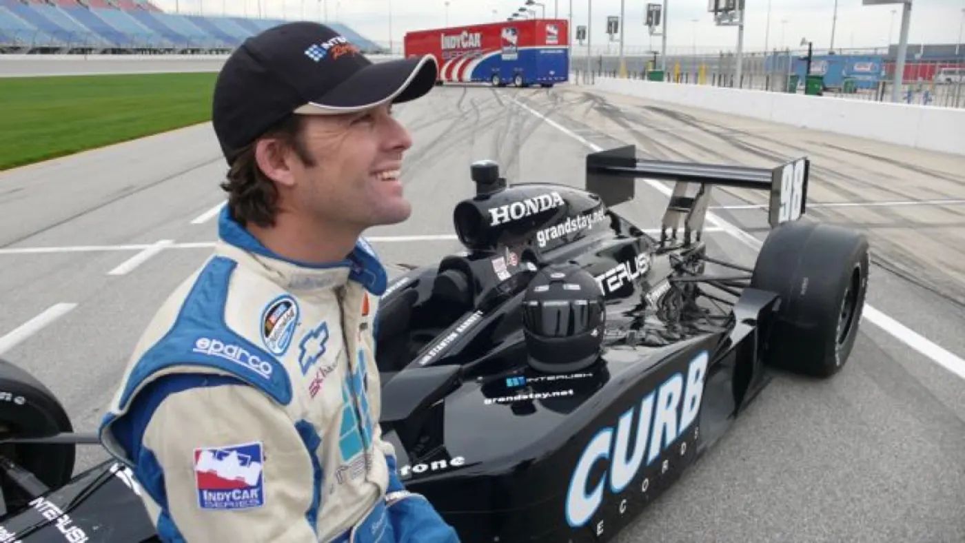 Stanton Barrett beside an IndyCar