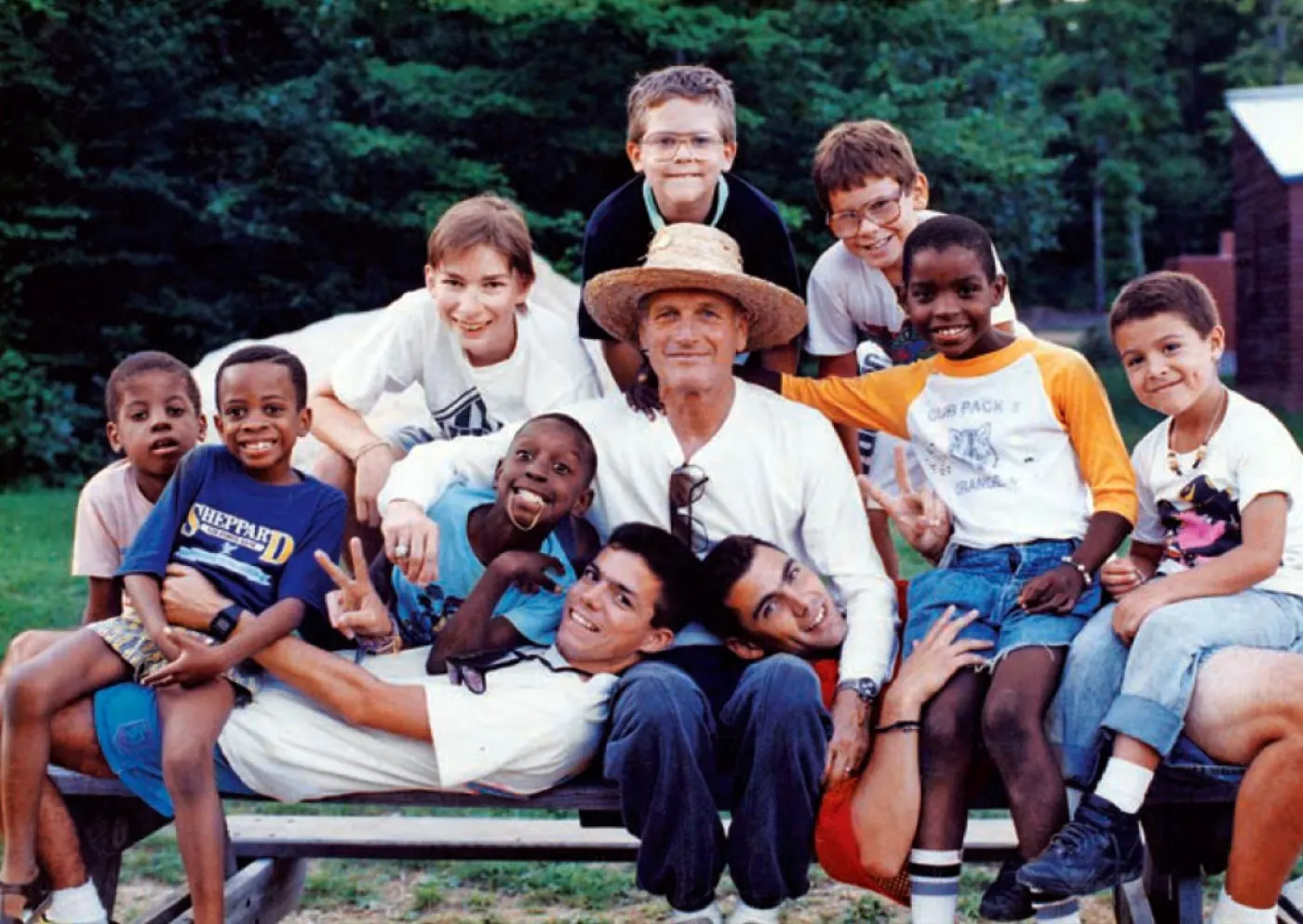 Paul Newman surrounded by children at his camp